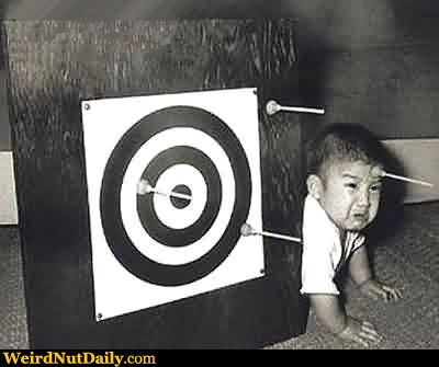 Baby Making Picture Generator on Dart Board With Baby Next To It With Suction Dart On Forehead
